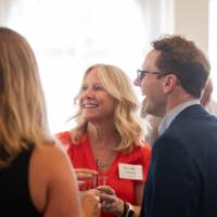 Dorothy VanderJagt talking with three other event attendees in circle